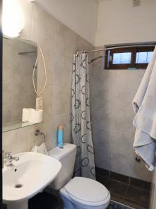 a bathroom with a white toilet and a sink at Sentite como en casa in Mendoza +9 photos