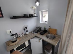 a small kitchen with a counter with a sink at 284 on Circular 2 in Sunridge Park