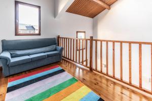 a living room with a couch and a colorful rug at House with garden and fireplace in Osséja