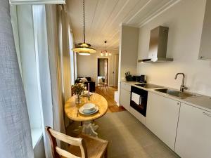 a small kitchen with a table and a sink at Apartment in the centre of Viljandi in Viljandi +5 photos