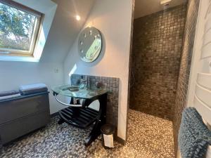 a bathroom with a glass sink and a shower at Gites la Rifflais - L'étang - vue sur étang privé in Langrolay +6 photos