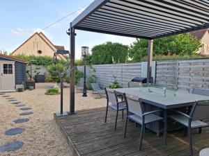 a patio with a table and chairs on a deck at Chambre avec SDB privative et parking MOTO ou VL in Romorantin