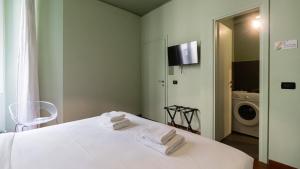 a bedroom with a white bed with towels on it at Italianway - Tadino 1 B in Milan