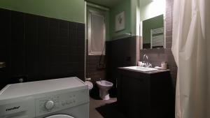 a bathroom with a washing machine and a sink at Italianway - Tadino 1 B in Milan +19 photos