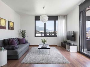 a living room with a couch and a table at ibis Locarno in Locarno