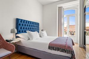 a bedroom with a large bed and a window at Tesouro da Baixa by Shiadu in Lisbon