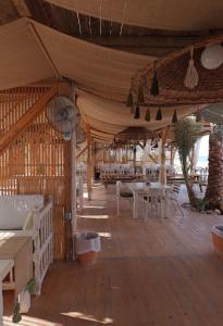a tent with tables and chairs in a room at 2 Bedroom Chalet pool& sea view just steps from the sea fanar de luna ain sokhna in Ain Sokhna