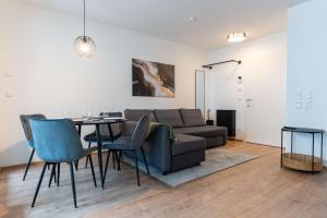 a living room with a couch and a table at CasaVia BB03 with parking up to 4 people kitchen central in Böblingen