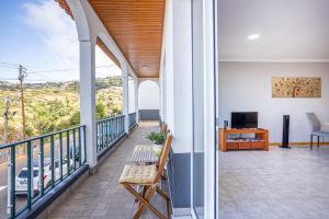a balcony with a view of a street at Estrela house II Calheta Madeira in Calheta