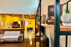 a living room with a bed and a kitchen at Studio Lua Nova - Cabanas Lua Nova in Penedo