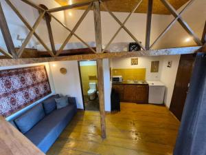 a living room with a blue couch and a kitchen at Toti guest house 2 in São Tomé