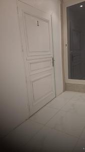 a white door with a window in a room at بيت الضباب in Abha +3 photos