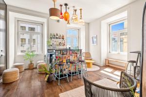 a room with a bar with chairs and windows at Tesouro da Baixa by Shiadu in Lisbon