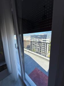 a view of a balcony from a room with a window at Mikels Apartment in Tirana