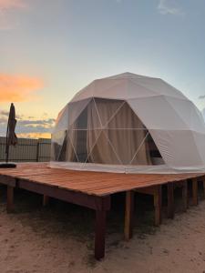 a tent on top of a wooden picnic table at Issyk-Kul Glamping in Chon-Sary-Oy +25 photos