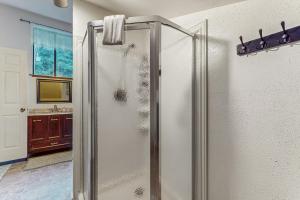 a shower in a bathroom with a sink at Peaceful Creekside in Orick +13 photos