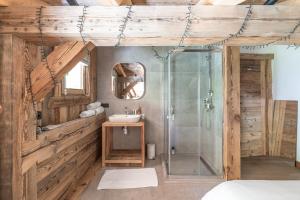 a bathroom with a glass shower and a sink at Le Chalet des Serves in Demi-Quartier +28 photos