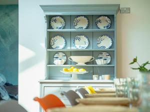 a shelf with blue and white plates on it at Y Graiglwyd in Amlwch +21 photos