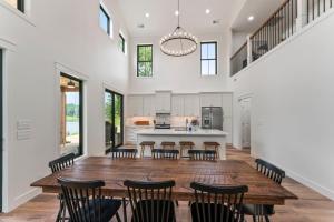 an open kitchen and dining room with a large wooden table and chairs at Lakeside Retreat in Kingston