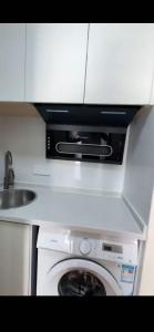 a kitchen with a washing machine and a sink at Aisen BNB National Exhibition Center Hongqiao Shanghai in Shanghai