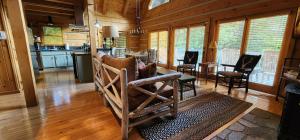 a kitchen and living room with a table and chairs at The Bigwitch Cabin in Cherokee