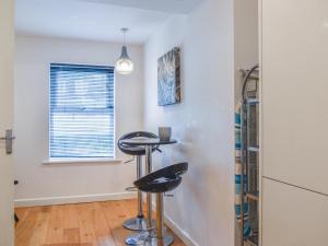 a room with a bar stool and a window at Palm Court in Bournemouth