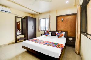 a bedroom with a large bed in a room at Via Sun n Shine in Pune