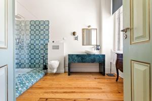 a bathroom with a blue sink and a toilet at Tesouro da Baixa by Shiadu in Lisbon +45 photos