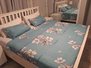 a bed with a blue blanket and pillows on it at Nely y Pietro share apartment in Punta Cana