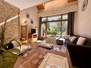 a living room with a table with wine glasses on it at Chalet en Duplex 10 Pers. avec Terrasse/Jardin, Proche Pistes – La Salle les Alpes - FR-1-330F-3 in La Salle Les Alpes