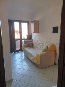 a bedroom with a bed with a laptop on it at Case Verdemare Stintino in Stintino