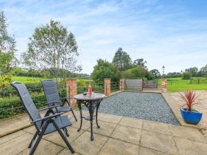 a patio with two chairs and a table at Overshot - Uk45388 in Crewkerne