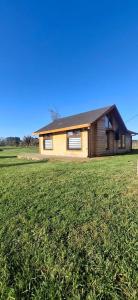 a house with a grass field in front of it at Cabañas en Valdivia in Valdivia