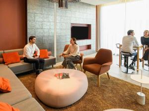 a group of people sitting in a living room at Aparthotel Adagio Muenchen City in Munich