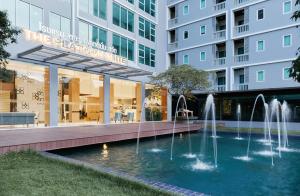 a building with a fountain in front of a building at Sunday Platinum Suites in Bangkok +51 photos