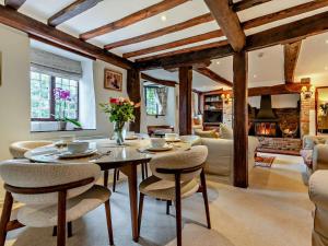 a living room with a table and chairs at 3 bed property in Blandford Forum 83442 in Tarrant Monkton