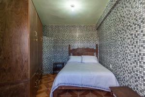 En eller flere senge i et værelse på Apto Acolhedor prox Palácio do Ouro, Garagem, Pet
