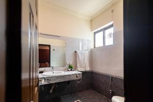 a bathroom with a sink and a mirror at Shelton Rezidor Jinnah Super in Islamabad +46 photos