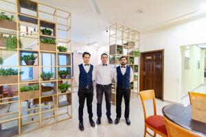 three men wearing bow ties standing in a room at Shelton Rezidor Jinnah Super in Islamabad