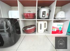 a kitchen shelf with pots and pans and a appliance at Homestay Meru Ipoh Mus Lim Only Tropical White House in Ipoh