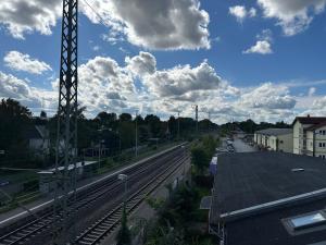 a view of a train track with clouds in the sky at Boutique Apartment im historischen Bahnhof - Potsdam & Berlin in Potsdam