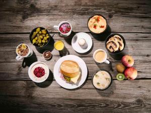 a table topped with plates of food and drinks at B&B Hotel Graz-Hbf in Graz