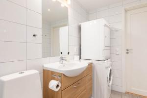 a white bathroom with a sink and a toilet at Åre Travel - Brygghusen in Åre +38 photos