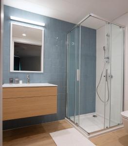 a bathroom with a shower with a sink and a toilet at PINEA Resort in Pobierowo