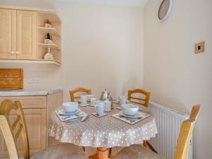 a dining room table with a polka dot table cloth at Eryb Cottage - Uk46883 in Kilmory