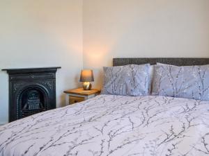 a bedroom with a bed and a fire place at The Apartment in Filey
