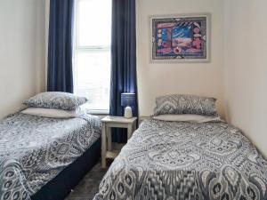 a bedroom with two beds and a window at The Apartment in Filey +10 photos