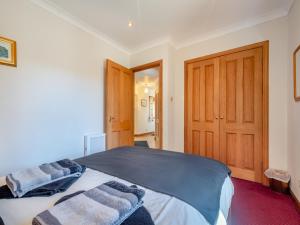 a bedroom with a large bed with towels on it at Eryb Cottage - Uk46883 in Kilmory +6 photos
