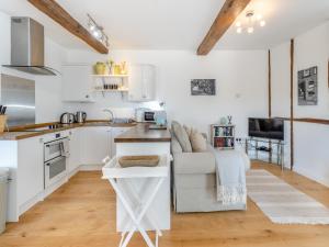 a kitchen and living room with a couch and a table at Rambler's Hideaway - Uk45414 in Eaton Bishop