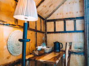 a lamp on a wooden table in a room at Samora River Lodge in Arusha